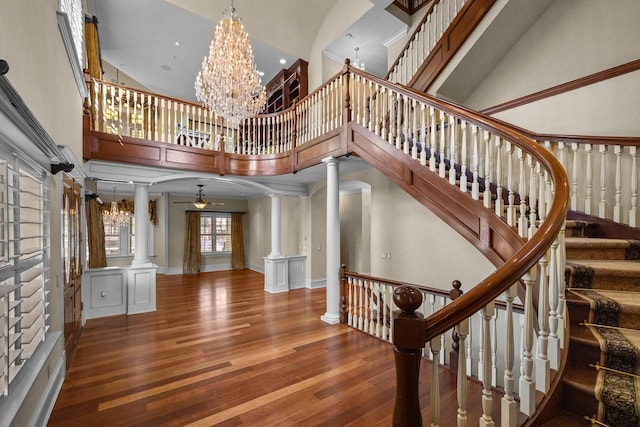 305 Columbia Ave, Whitefish, MT 59937 - stairs featuring ornate columns, wood finished floors, a towering ceiling, and a chandelier
