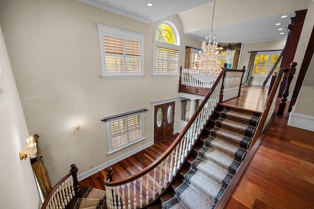 305 Columbia Ave, Whitefish, MT 59937 - stairway with a chandelier, wood finished floors, crown molding, recessed lighting, and a high ceiling