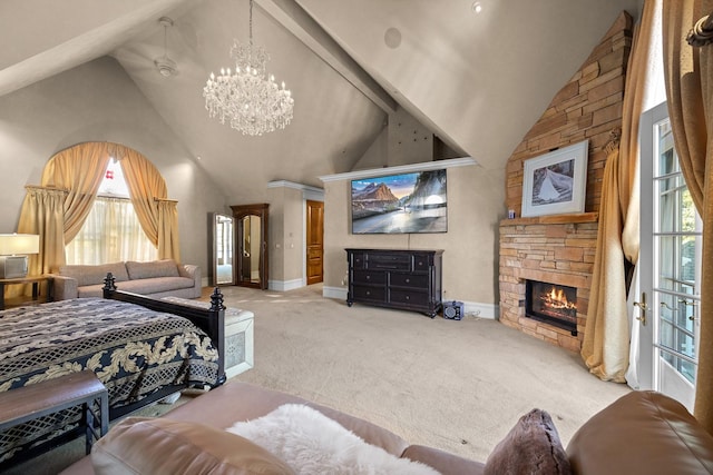 305 Columbia Ave, Whitefish, MT 59937 - carpeted bedroom featuring a chandelier, multiple windows, high vaulted ceiling, and a stone fireplace