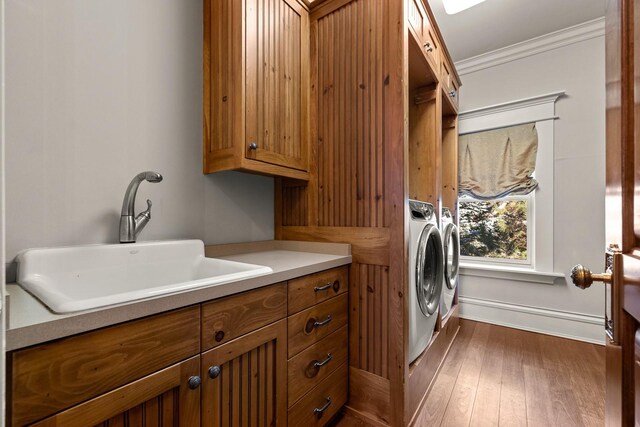 305 Columbia Ave, Whitefish, MT 59937 - laundry room with separate washer and dryer, cabinet space, dark wood-style floors, and ornamental molding
