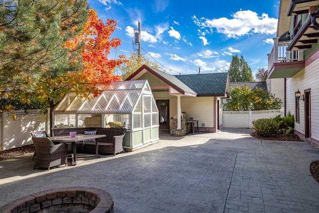 305 Columbia Ave, Whitefish, MT 59937 - rear view of house with an exterior structure, a patio, outdoor dining space, and an outbuilding