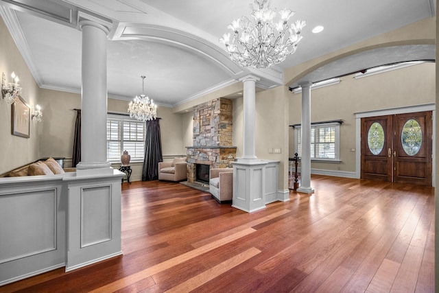 305 Columbia Ave, Whitefish, MT 59937 - foyer with ornate columns, a chandelier, wood-type flooring, and ornamental molding