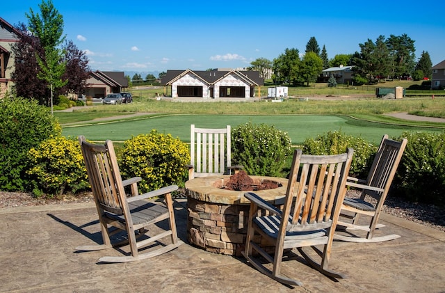 187 Meadow Vista Loop Unit A, Kalispell, MT 59901 - view of green lawn featuring an outdoor fire pit and a patio area