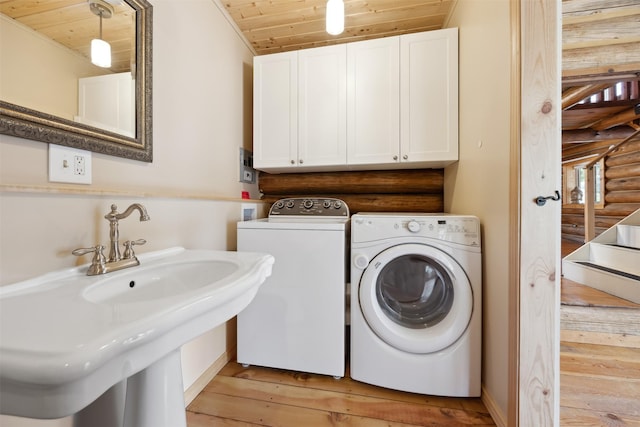 1441 Bonanza Dr, Sula, MT 59871 - laundry area with washing machine and clothes dryer, wooden ceiling, light wood finished floors, log walls, and a sink