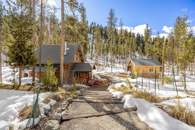 1441 Bonanza Dr, Sula, MT 59871 - snow covered back of property with metal roof and log exterior