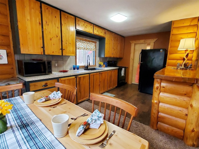 4056 Snow Fleury Ln, Lincoln, MT 59639 - kitchen with black appliances, log walls, light countertops, a sink, and dark wood-style floors