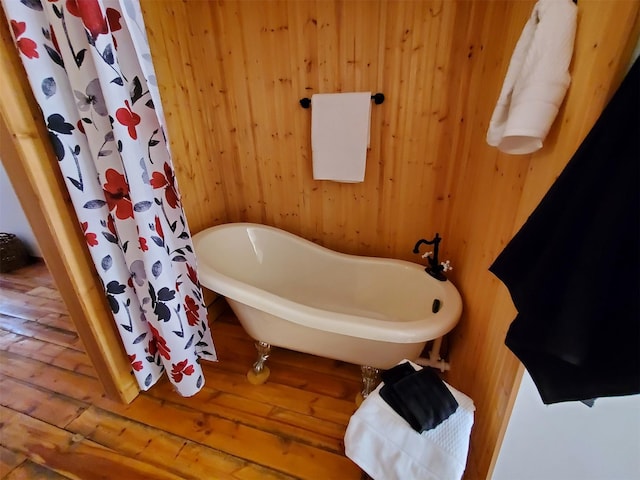4056 Snow Fleury Ln, Lincoln, MT 59639 - full bath featuring hardwood / wood-style flooring, a freestanding bath, and wooden walls