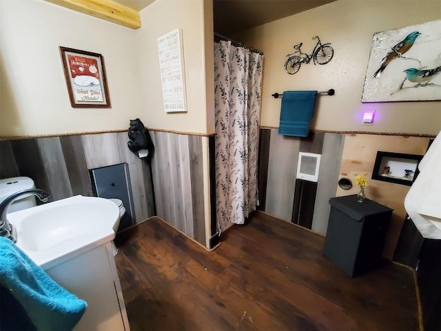 4056 Snow Fleury Ln, Lincoln, MT 59639 - full bath featuring wood finished floors, a sink, wainscoting, and a shower with shower curtain