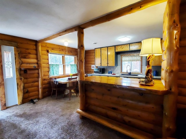 4056 Snow Fleury Ln, Lincoln, MT 59639 - kitchen featuring a sink, stainless steel microwave, rustic walls, carpet floors, and beam ceiling