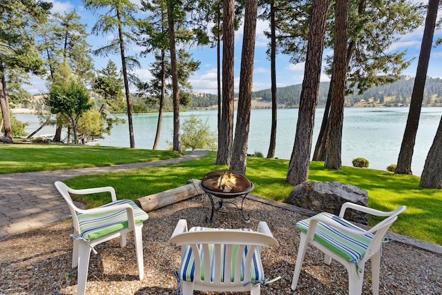 662 S Foys Lake Dr, Kalispell, MT 59901 - view of green lawn featuring a fire pit and a water view