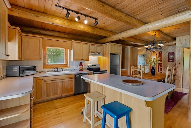 662 S Foys Lake Dr, Kalispell, MT 59901 - kitchen with stainless steel appliances, light wood-type flooring, a wood ceiling with exposed beams, rail lighting, and a chandelier