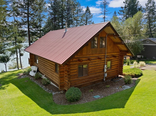 662 S Foys Lake Dr, Kalispell, MT 59901 - view of side of property featuring log siding, a standing seam roof, and a yard