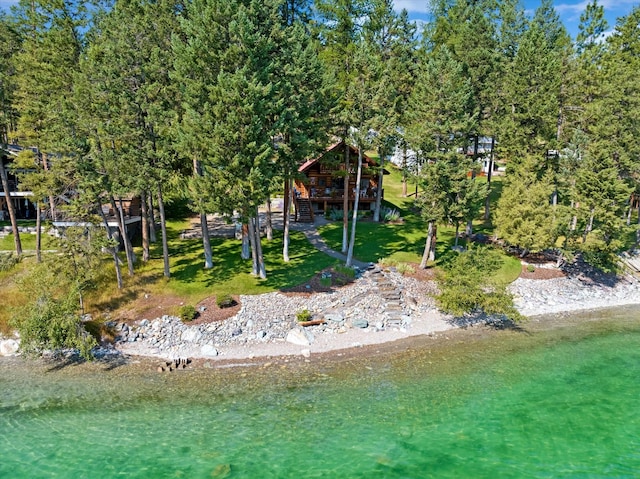 662 S Foys Lake Dr, Kalispell, MT 59901 - rear view of house with a deck, a lawn, and stairs