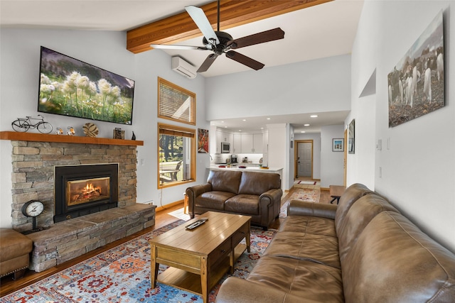 living area featuring a ceiling fan, high vaulted ceiling, beam ceiling, a stone fireplace, and a wall mounted AC