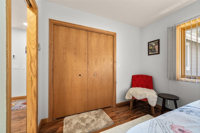 bedroom featuring baseboards, a closet, and wood finished floors
