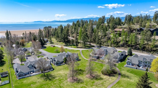 drone / aerial view with a water and mountain view and a residential view