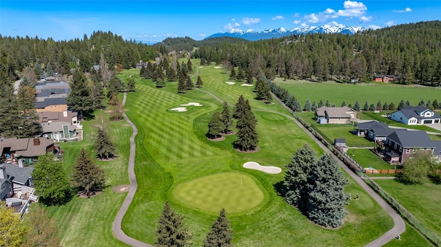 bird's eye view featuring a view of trees, a residential view, a mountain view, and view of golf course