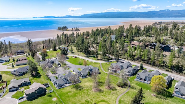 birds eye view of property featuring a water and mountain view and a residential view