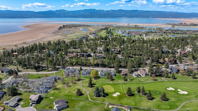 birds eye view of property with a water and mountain view, view of golf course, and a residential view