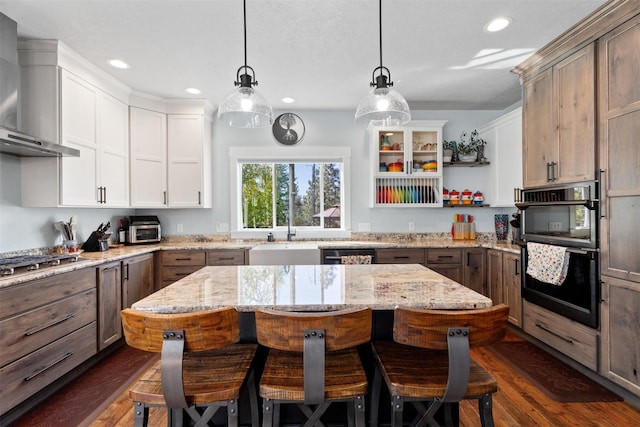 kitchen featuring wall chimney exhaust hood, a sink, open shelves, stainless steel gas cooktop, and recessed lighting