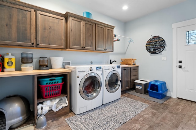 laundry area with cabinet space, washing machine and dryer, and recessed lighting