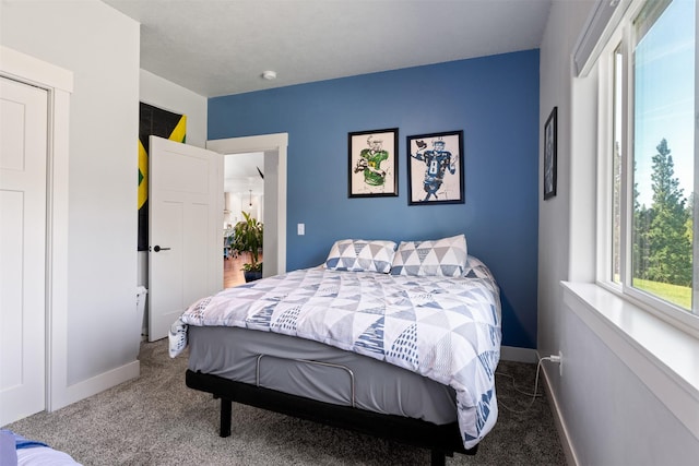 carpeted bedroom featuring baseboards