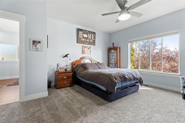 bedroom with baseboards, carpet floors, and ceiling fan