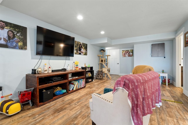 living area with wood finished floors, recessed lighting, and baseboards