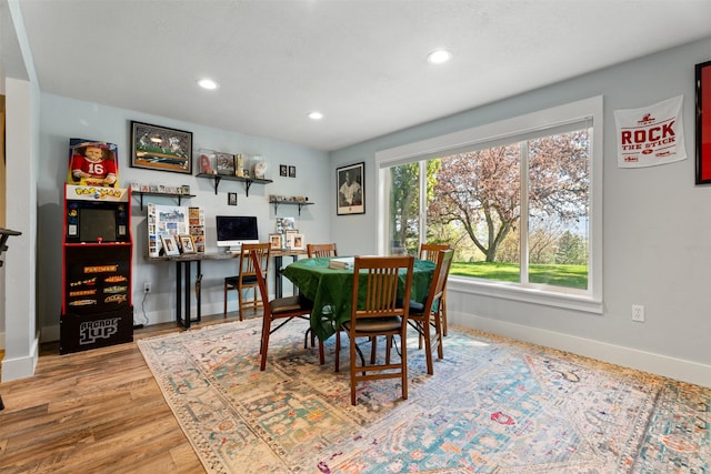 dining room featuring baseboards, recessed lighting, and wood finished floors