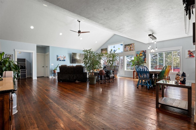 living room featuring ceiling fan, wood-type flooring, a textured ceiling, high vaulted ceiling, and baseboards