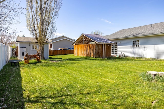 view of yard featuring an outbuilding and a fenced backyard