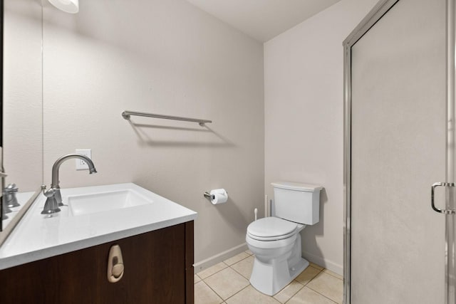 full bathroom featuring toilet, a stall shower, tile patterned floors, baseboards, and vanity