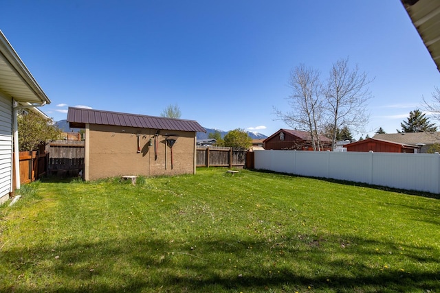 view of yard with a fenced backyard and an outdoor structure