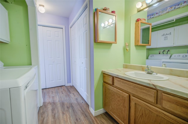 2449 Belt View Dr Unit B, Helena, MT 59601 - bathroom featuring washing machine and dryer, vanity, and wood finished floors