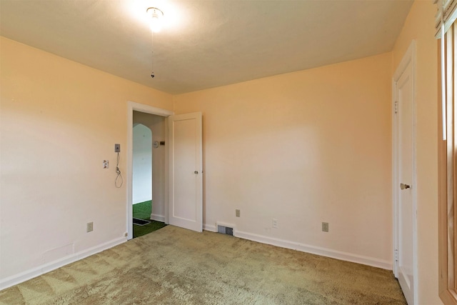 unfurnished bedroom with carpet floors, baseboards, and visible vents