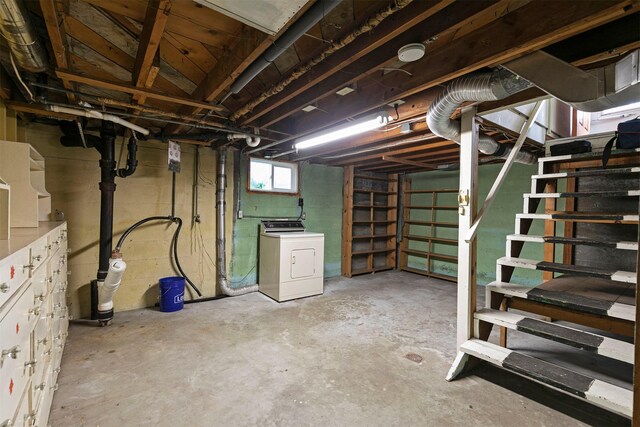 basement with stairs and washer / dryer