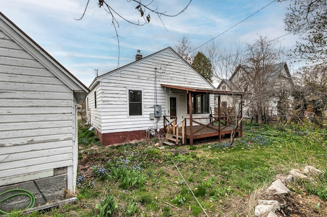 rear view of house featuring a deck