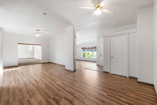 61574 Hillside Rd, Saint Ignatius, MT 59865 - unfurnished living room featuring ceiling fan, baseboards, and wood finished floors
