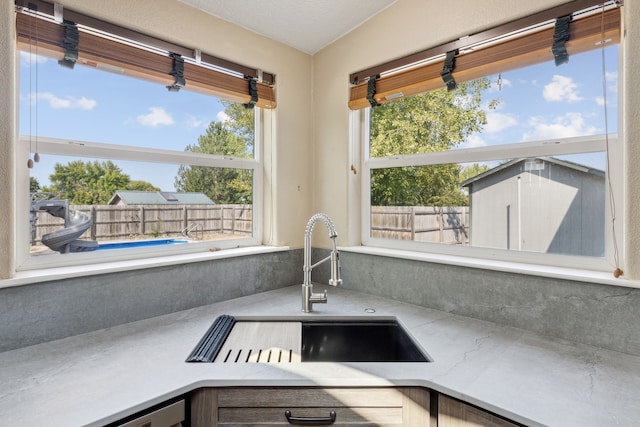 61574 Hillside Rd, Saint Ignatius, MT 59865 - kitchen with light countertops, decorative backsplash, and a sink