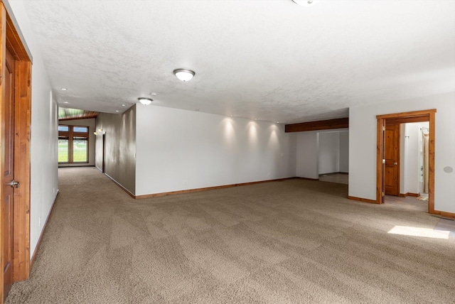 61574 Hillside Rd, Saint Ignatius, MT 59865 - empty room featuring baseboards, light carpet, and a textured ceiling