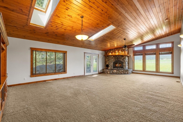 61574 Hillside Rd, Saint Ignatius, MT 59865 - unfurnished living room with a stone fireplace, wooden ceiling, plenty of natural light, and vaulted ceiling with skylight
