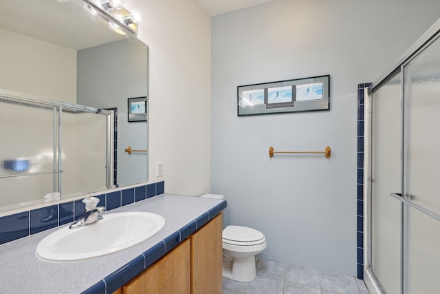 61574 Hillside Rd, Saint Ignatius, MT 59865 - full bath with vanity, a shower with door, toilet, and tile patterned flooring