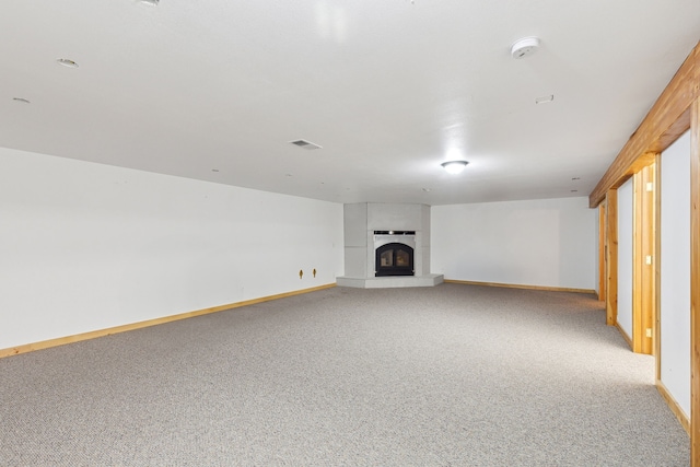 61574 Hillside Rd, Saint Ignatius, MT 59865 - unfurnished living room featuring baseboards, a glass covered fireplace, visible vents, and carpet