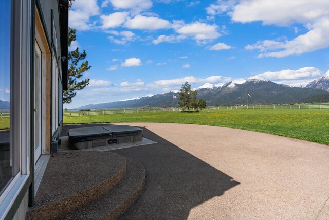 61574 Hillside Rd, Saint Ignatius, MT 59865 - view of patio featuring a rural view, a mountain view, and fence