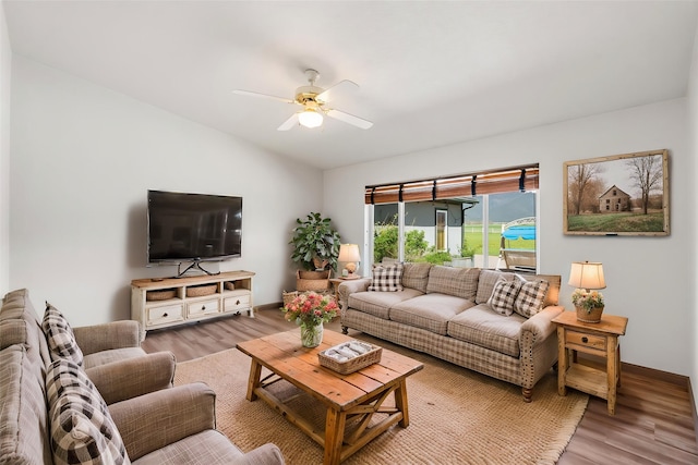 61574 Hillside Rd, Saint Ignatius, MT 59865 - living area featuring vaulted ceiling, baseboards, a ceiling fan, and wood finished floors