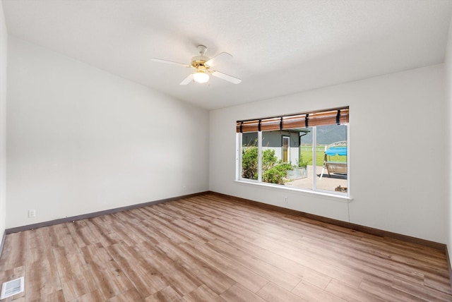 61574 Hillside Rd, Saint Ignatius, MT 59865 - unfurnished room featuring baseboards, visible vents, a ceiling fan, and wood finished floors