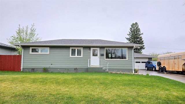 ranch-style house featuring a front lawn, a garage, fence, and entry steps