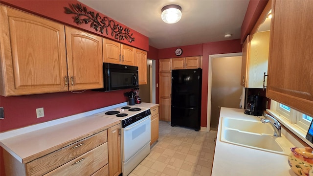 kitchen with black appliances, light countertops, and a sink