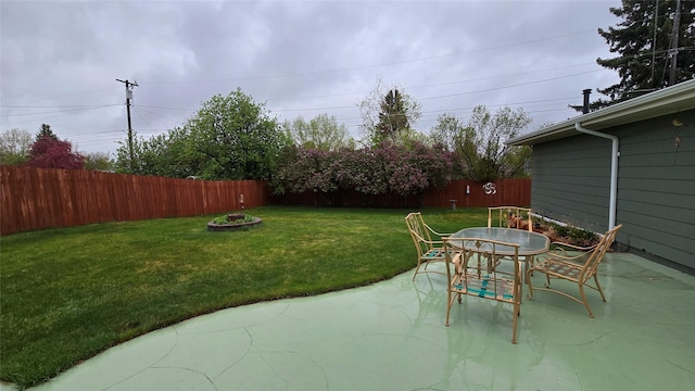 view of yard with a patio area, outdoor dining area, and a fenced backyard
