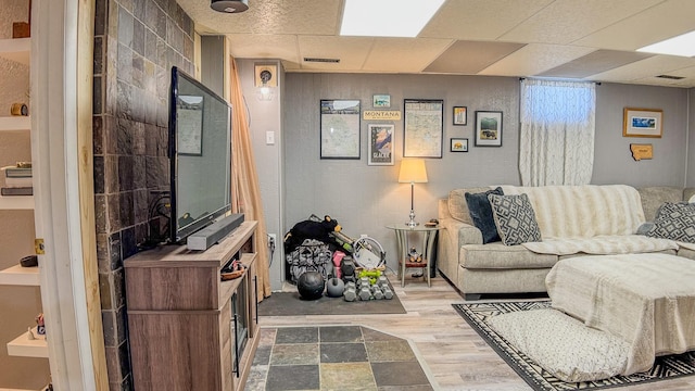 living area with visible vents and wood finished floors
